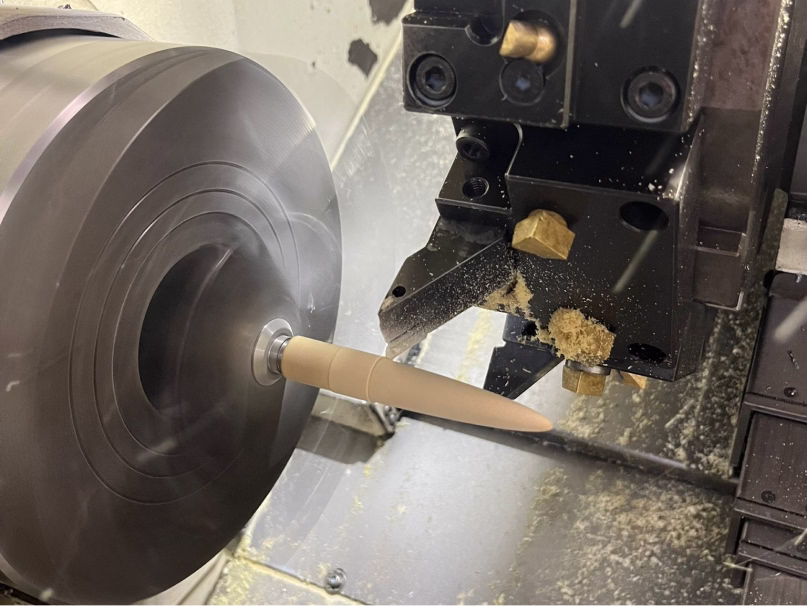 A craftsman turning an Aeon fountain pen body on a lathe