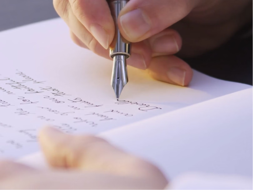 A hand writing with a bespoke Ashera fountain pen
